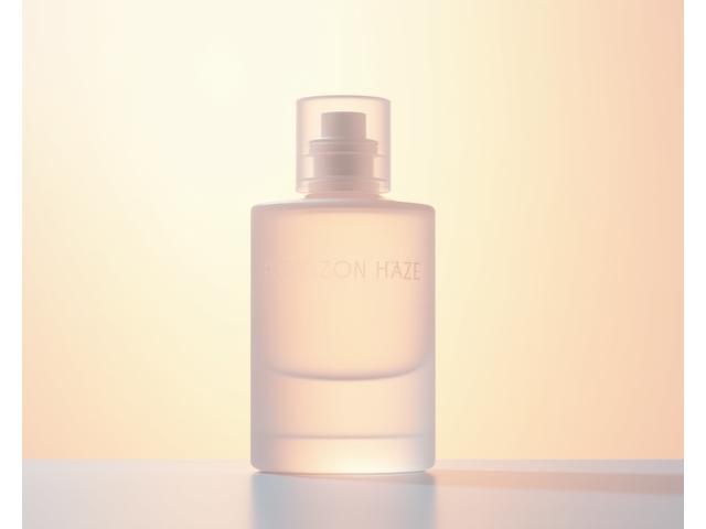 A modern, minimalist bottle of 'Horizon Haze' with soft, glowing sunlight, conveying a sense of newness and popularity.