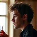 Soren Lund, a perfumer, observing condensation in a distillation apparatus for natural extracts.